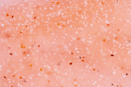 Cosmetics scrub texture swatch, body scrub in peach fuzz color. Top view. Flat lay, top view. Scrub backgroundの写真素材