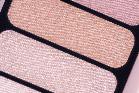 Professional multicolor eyeshadow makeup palette, top view. Macro texture of eyeshadows. Makeup eyeshadow palette in brown-beige colors. Rectangular eyeshadowsの写真素材