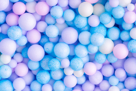 Colorful balls background in pink and blue colors. Abstract background with colorful balls in different sizes. Sphere of balls on pastel color.の写真素材