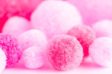 Colorful mini pom poms, pink and white. Heap of small pastel color fluffy ball, macro shotの写真素材