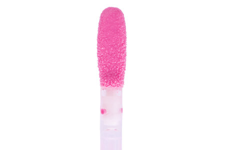 Pink lip gloss applicator brush isolated on a white background. Swatch of light pink lipglossの写真素材
