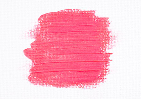 Pink shimmer paint brush on white background on white canvas. Pink glitter acrylic paint stain on the white paper wall, macroの写真素材