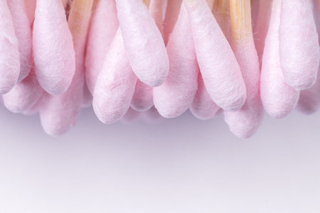 Heap of light pink cotton buds on white background, top view with copy spaceの写真素材