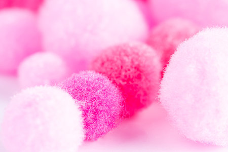 Colorful mini pom poms, pink and white. Heap of small pastel color fluffy ball, macro shotの写真素材