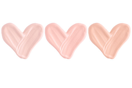 Swatch of foundation cream or concealer in the shape of a heart isolated on white background, macro. Set of hearts from foundation cream smear smudge texture different hue colors.の写真素材