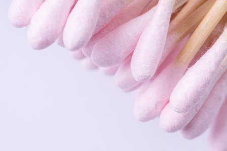 Heap of bamboo pink cotton swabs on white background wirh copy spaceの写真素材