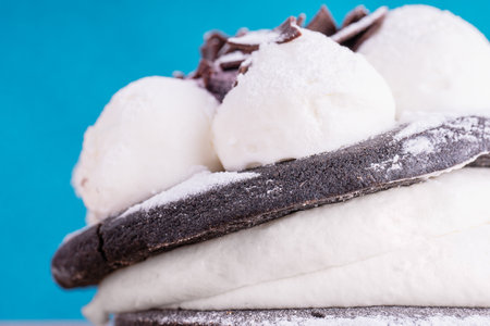 Delicious chocolate cupcakes with cream on blue background, macro shotの写真素材