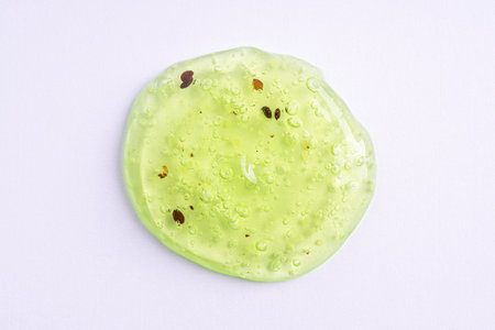 Transparent green cosmetic sample texture with bubbles. Cosmetic peeling gel with fruits. Swatch of cosmetic scrub, beauty backgroundの写真素材