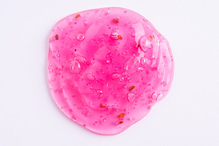 Transparent pink cosmetic sample texture with bubbles. Cosmetic peeling gel with raspberry. Cosmetic rose pink peeling gel, beauty backgroundの写真素材