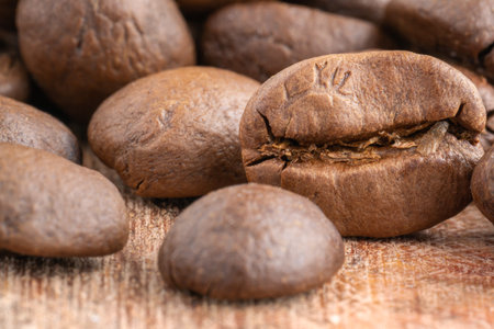 Close up of coffee beans on a wooden background. Fresh coffee beans, macro shotの写真素材