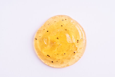 Transparent orange cosmetic sample texture with bubbles. Swatch of cosmetic peeling gel. Cosmetic scrub, beauty backgroundの写真素材