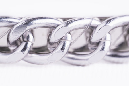 Steel chain macro on white background, copy space. Closeup of iron chainの写真素材