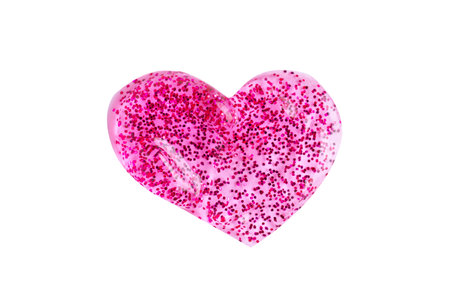 Pink shimmering lip gloss texture in heart shape, texture stroke isolated on white background. Cosmetic product swatch. Glitter samplesの写真素材
