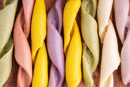 Strozzapreti Pasta, Italian traditional homemade pasta, macro shot, top view. Colorful Pasta, healthy food background. Multicolored Troffiette.の写真素材