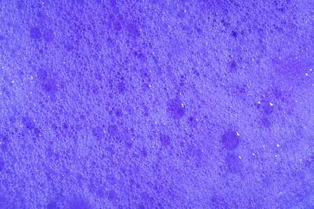 Purple foam. Violet lavender foaming soap closeup. Foam texture background. Macroの写真素材