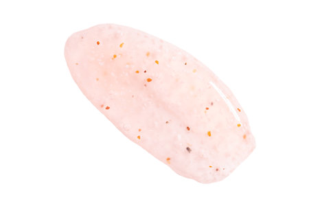 Transparent pink cosmetic sample texture with bubbles. Cosmetic peeling gel or scrub. Cosmetic peeling gel in peach fuzz color. Pink scrub smear isolated on white.の写真素材