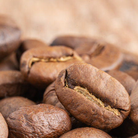 Close up of coffee beans on a wooden background. Fresh coffee beans, macro shotの写真素材