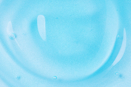 Clear blue gel fluid with bubbles, macro texture of cosmetics productの写真素材