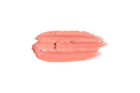 Orange clay mask smear smudge isolated on white background. Cream texture. Facial mask, skincare beauty product swatch closeup. SPA background.の写真素材