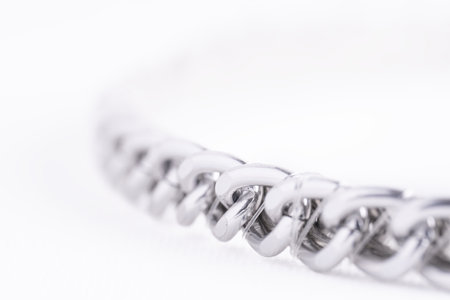 Steel chain macro on white background, copy space. Closeup of iron chainの写真素材