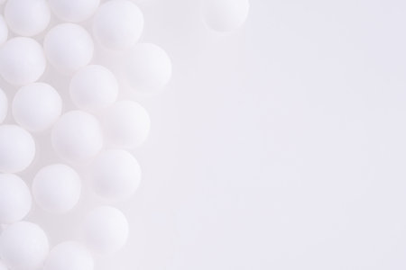 White balls on a white background. Background with mini white balls.の写真素材