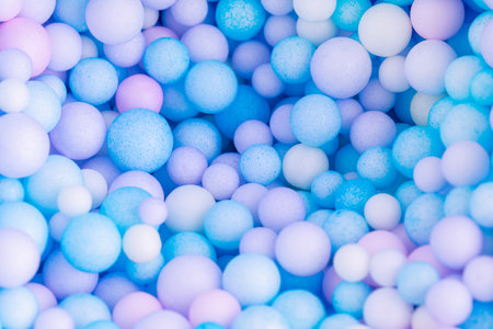 Colorful balls background in pink and blue colors. Abstract background with colorful balls in different sizes. Sphere of balls on pastel color.の写真素材