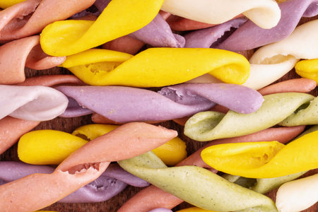 Strozzapreti Pasta, Italian traditional homemade pasta, macro shot, top view. Colorful Pasta, healthy food background. Multicolored Troffiette.の写真素材