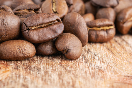 Close up of coffee beans on a wooden background. Fresh coffee beans, macro shotの写真素材