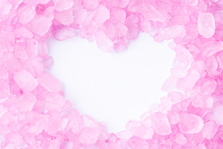 Pink bath salt with copy space is shape of a heart, macroの写真素材