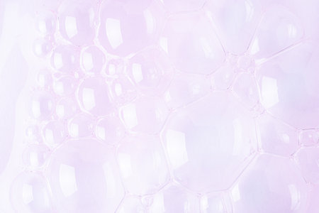 Molecule bubbles in a cosmetic serum, macro background. Clear pink cosmetic gel with molecule bubbles.の写真素材