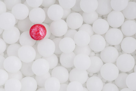 One red ball among many white balls. Different red ball.の写真素材