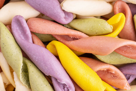Strozzapreti Pasta, Italian traditional homemade pasta, macro shot, top view. Colorful Pasta, healthy food background. Multicolored Troffiette.の写真素材