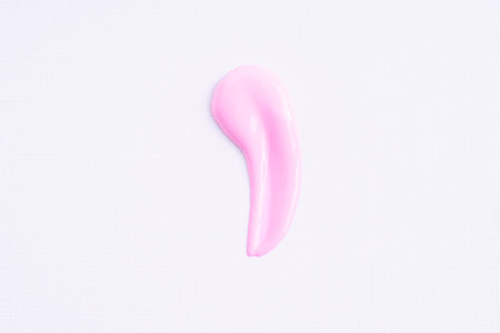 Pink cosmetic cream smear on white background. Face serum, lotion, moisturizer on white. Light pink paint swatch. Skincare product macroの写真素材