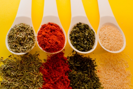 Cooking ingredients - herbs and spices yellow background の写真素材