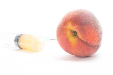 Peach and syringe の写真素材
