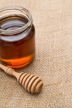 Honey with wood stick の写真素材