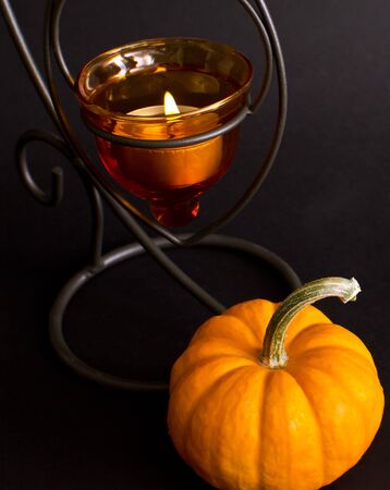 pumpkin and candle halloween studio shot on black backgroundの写真素材