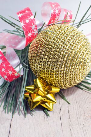 Gold Christmas ball and star on wooden background の写真素材