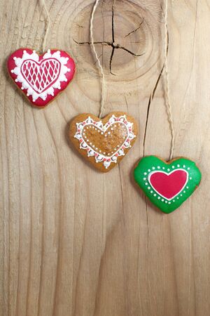 Gingerbread cookies hanging on wooden background  Christmas decoration  の写真素材
