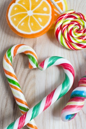 colorful lollipop on wooden backgroundの写真素材
