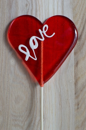 Heart lollipop on wooden backgroundの写真素材