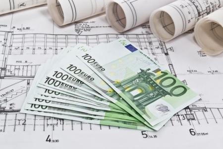Finance euro money with architectural blueprints rolls and plans の写真素材