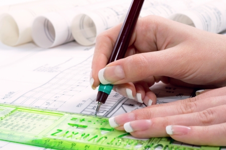 Design drawings and human hands drawing a project by pencil on paper の写真素材