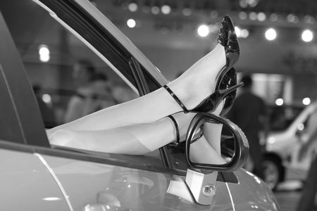 Beautiful women legs in car windowの写真素材