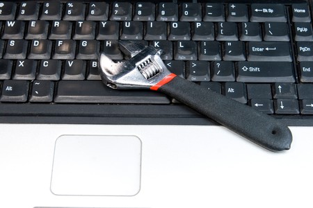 Spaner lying on keyboard of laptop