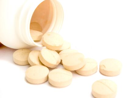 Tablets outside of bottle on white ground
の写真素材