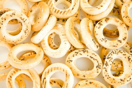 Bread-rings with poppyseeds on white groundの写真素材