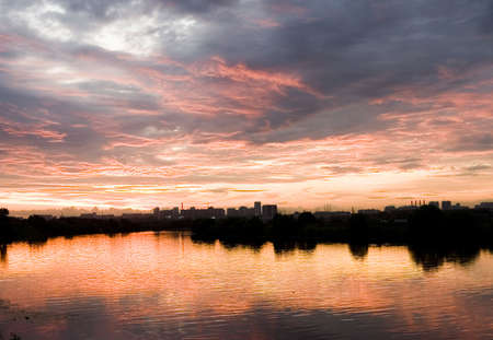 Sunset in clouds on the river