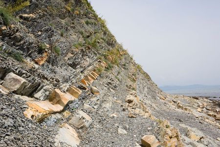 Rocky sea shore with small peace of waterの写真素材