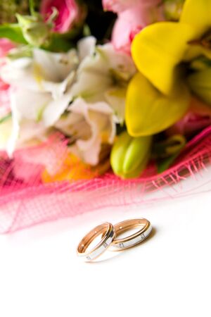 Composition of two wedding rings and flowersの写真素材